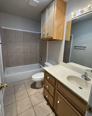a bathroom with a sink a toilet and bathtub
