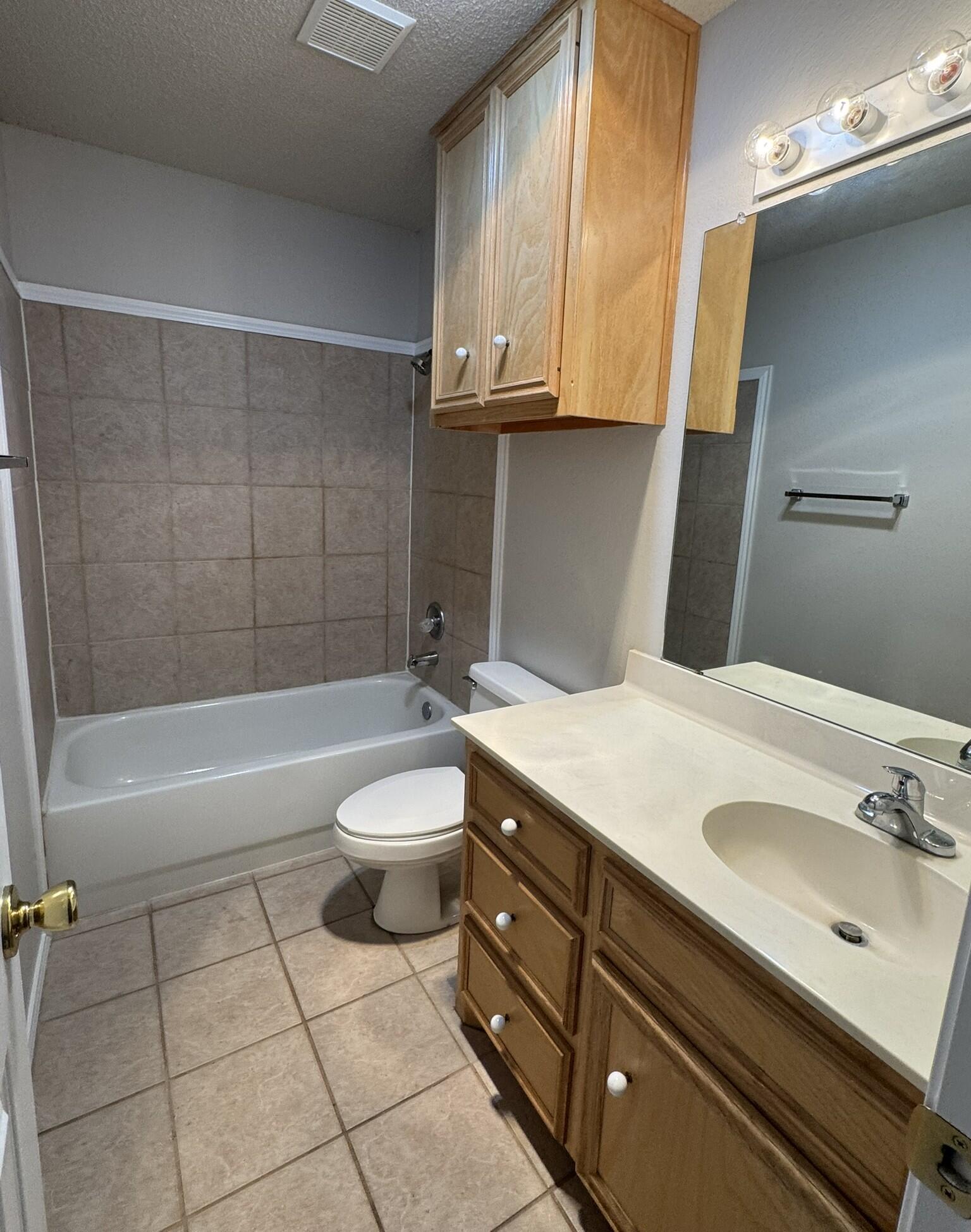 209 Grover Avenue Lubbock, TX 79416 - Photo 12 of 19 a bathroom with a sink a toilet and bathtub