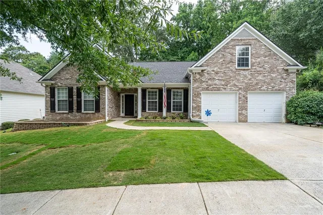 a front view of a house with a yard