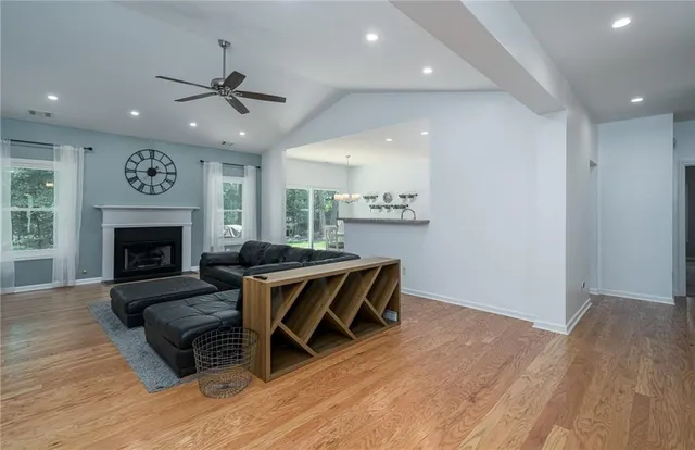 a living room with fireplace furniture and a flat screen tv