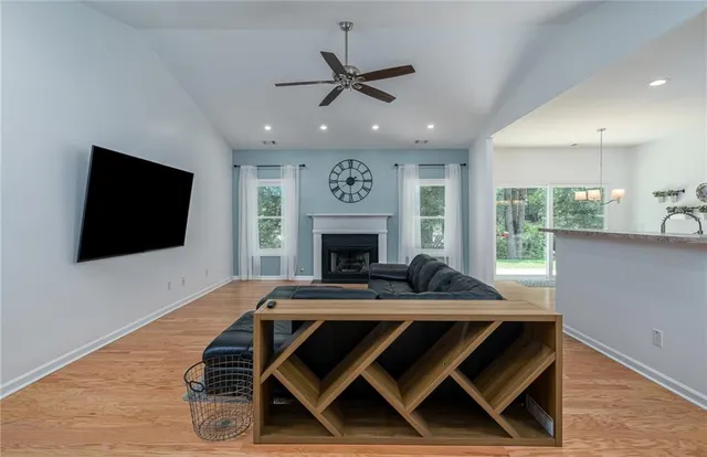 a view of a livingroom with furniture and a flat screen tv