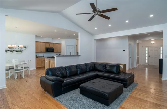 a kitchen with white cabinets stainless steel appliances and kitchen island