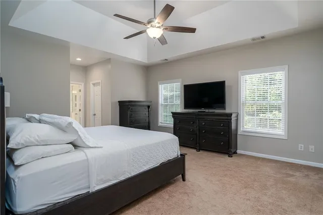 a bedroom with a bed and a ceiling fan