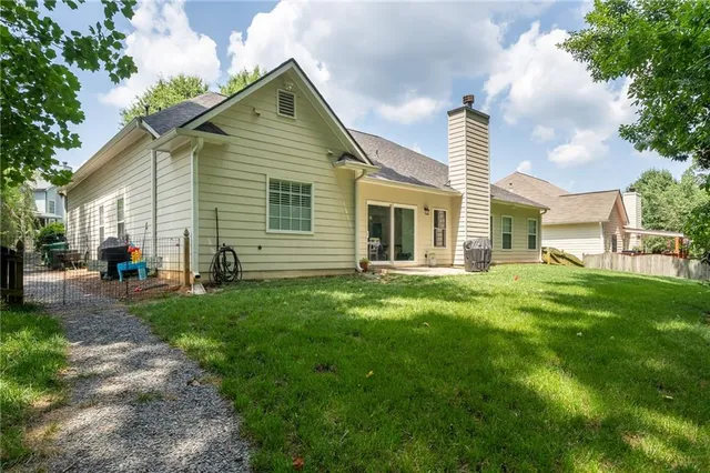 a view of a house with backyard and sitting area