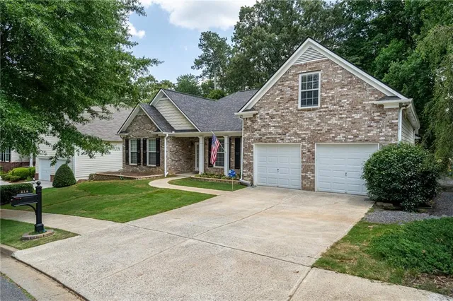a front view of house with yard and green space