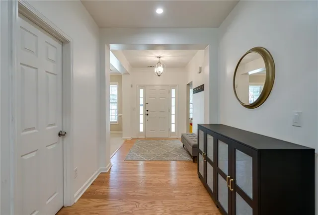 a view of a hallway with wooden floor and entryway