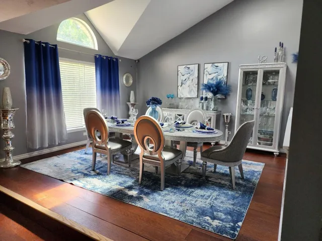 a view of a dining room with furniture window and wooden floor