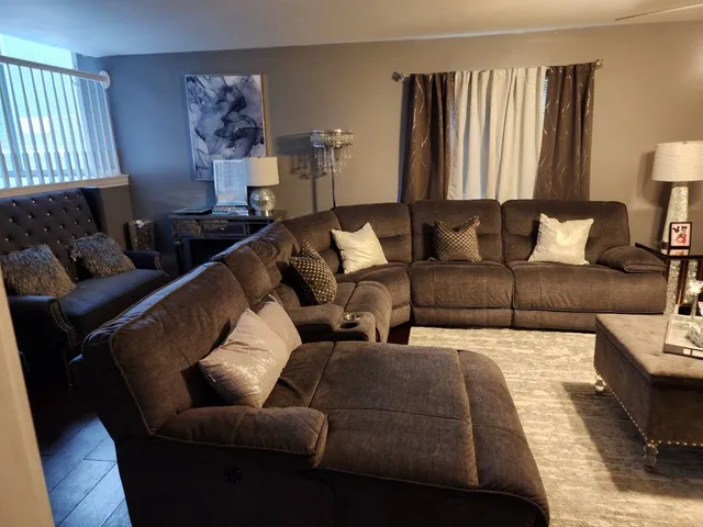 a living room with furniture and a lamp