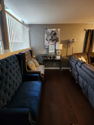 a living room with furniture and wooden floor