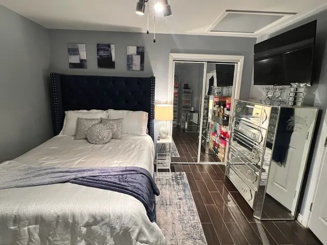 a bedroom with a bed and a flat screen tv