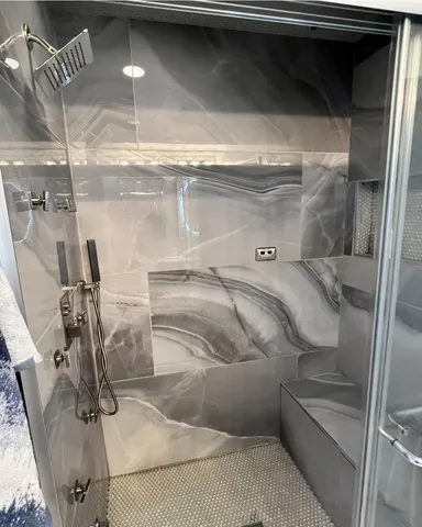 a bedroom with a bed window and a flat screen tv