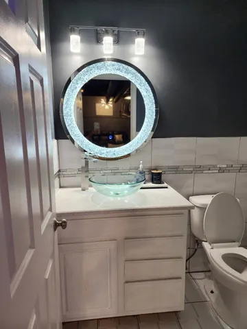 a living room with furniture and chandelier