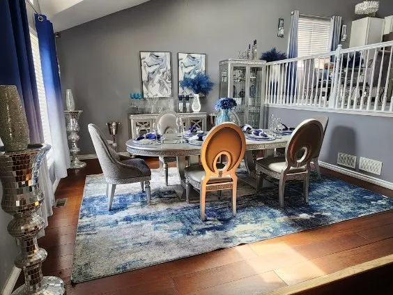 a dining room with furniture a rug and wooden floor
