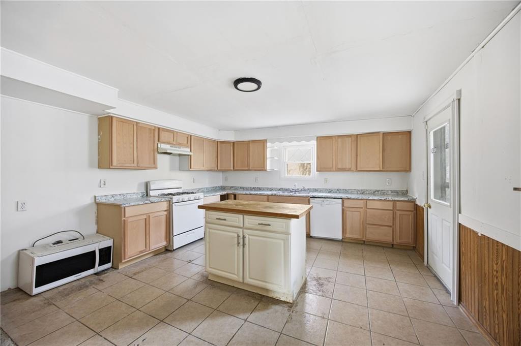 764 Mary Street McKees Rocks, PA 15136 - Photo 11 of 25 a kitchen with a stove top oven sink and cabinets