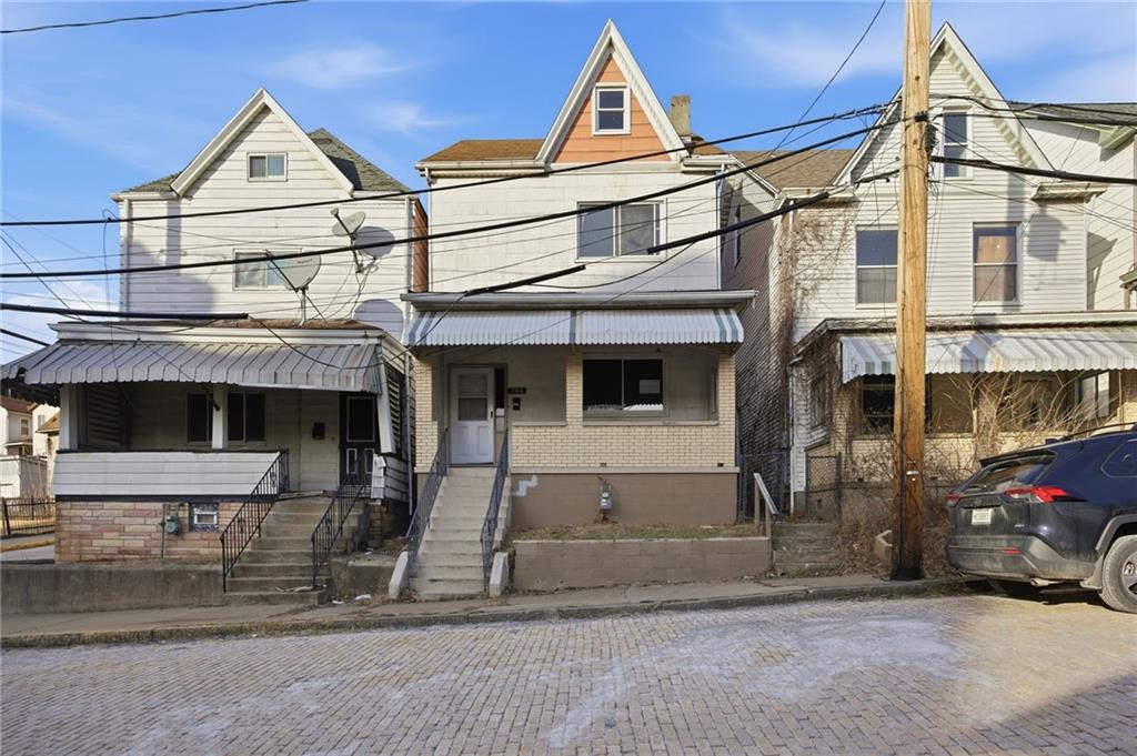 764 Mary Street McKees Rocks, PA 15136 - Photo 2 of 25 a view of a white house with large windows