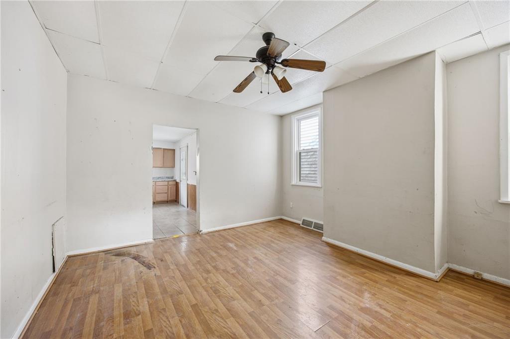 764 Mary Street McKees Rocks, PA 15136 - Photo 7 of 25 a view of empty room with wooden floor and ceiling fan