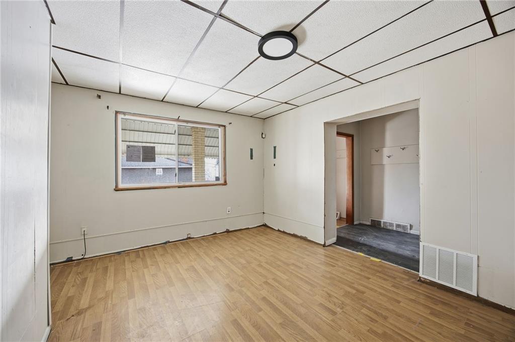 764 Mary Street McKees Rocks, PA 15136 - Photo 8 of 25 a view of an empty room with wooden floor and a window