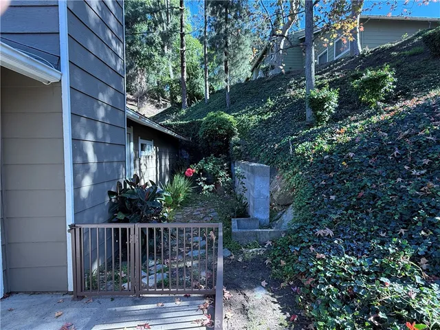 a view of a house with a small yard and wooden fence