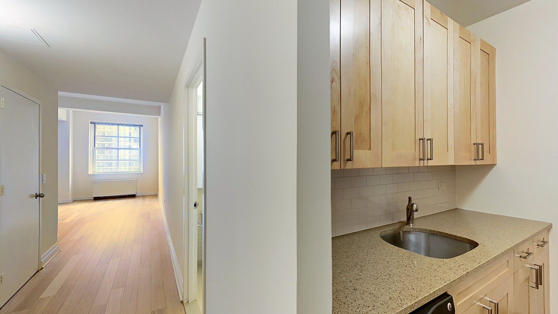 21 West Street, Unit 5H Manhattan, NY 10004 - Photo 2 of 8 a kitchen with a sink and cabinets