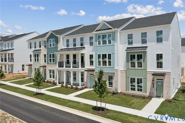 a front view of residential houses with yard