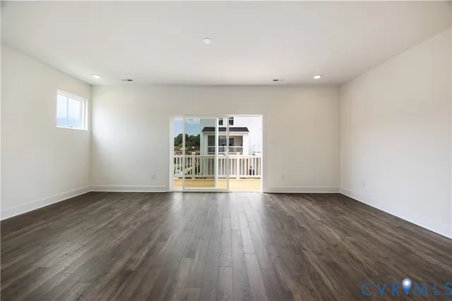 a view of wooden floor and windows in a room