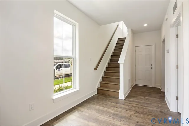 a view of an entryway with wooden floor and windows