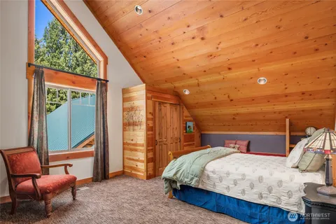 a bed room with a bed and chair