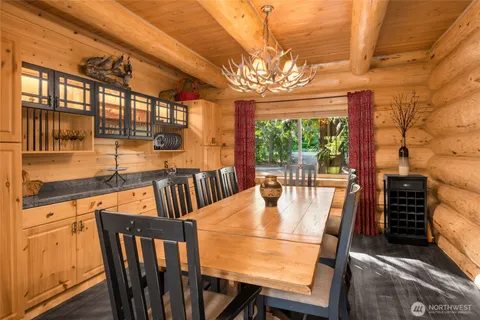 a view of a dining room with furniture a chandelier and wooden floor