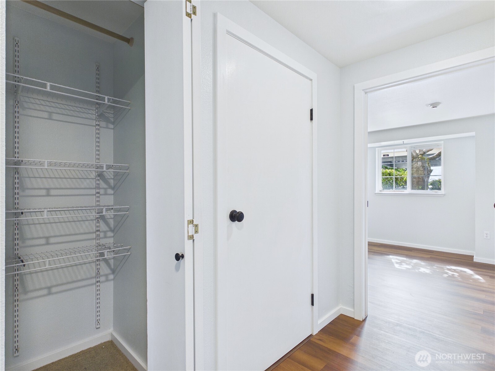 11002 Southeast Petrovitsky Road, Unit I102 Renton, WA 98055 - Photo 13 of 24 a view of hallway with wooden floor