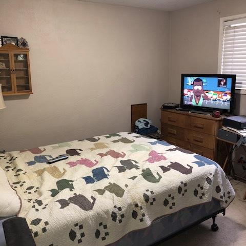 210-220 North 5th Street Central Point, OR 97502 - Photo 21 of 26 a bedroom with a bed and a flat screen tv