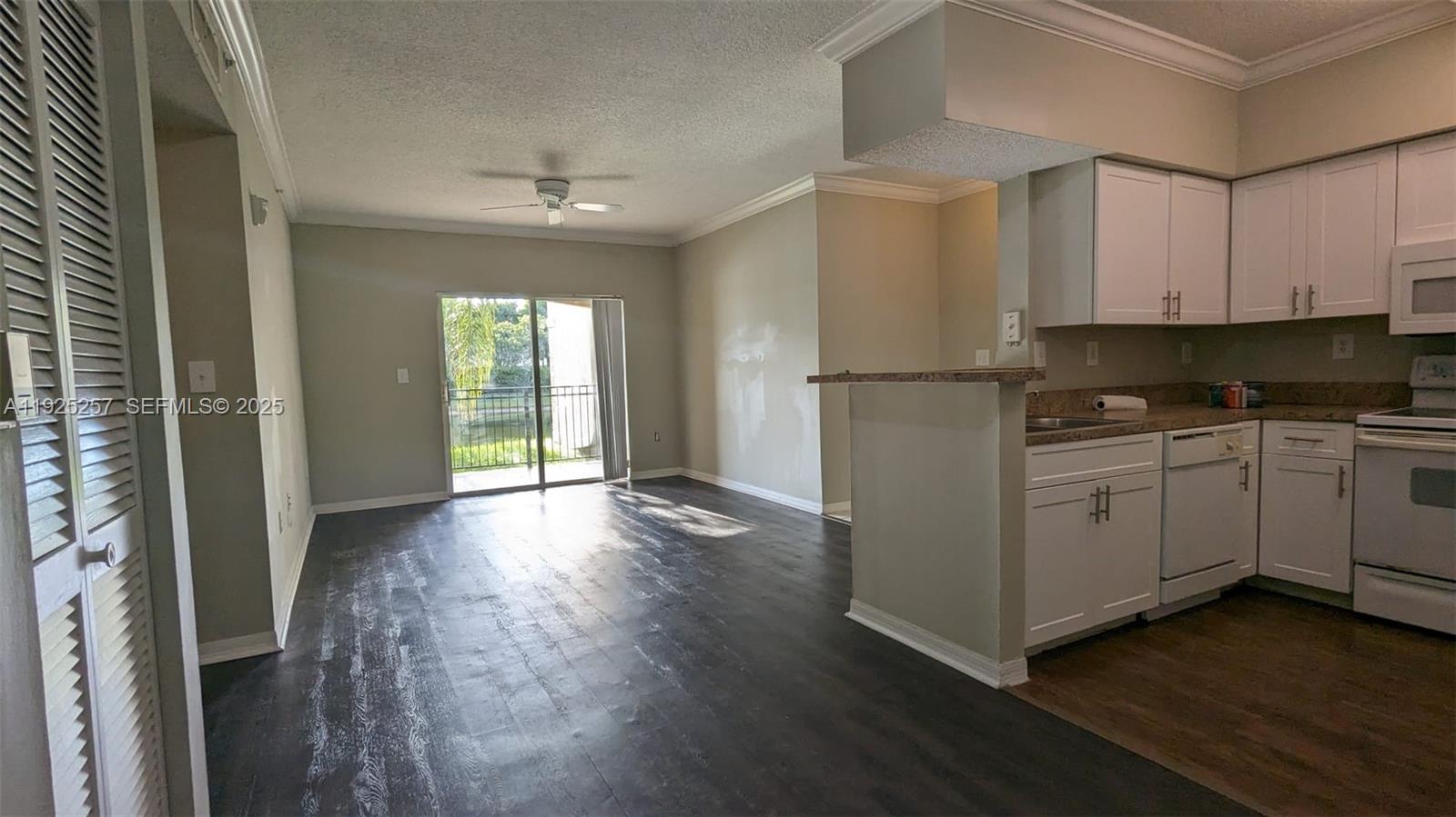 160 Southwest 117th Terrace, Unit 6106 Pembroke Pines, FL 33025 - Photo 12 of 28 a view of a kitchen with a white cabinet and a stove top oven