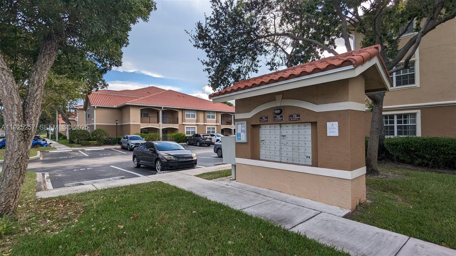 160 Southwest 117th Terrace, Unit 6106 Pembroke Pines, FL 33025 - Photo 19 of 28 a front view of a house with a garden and trees