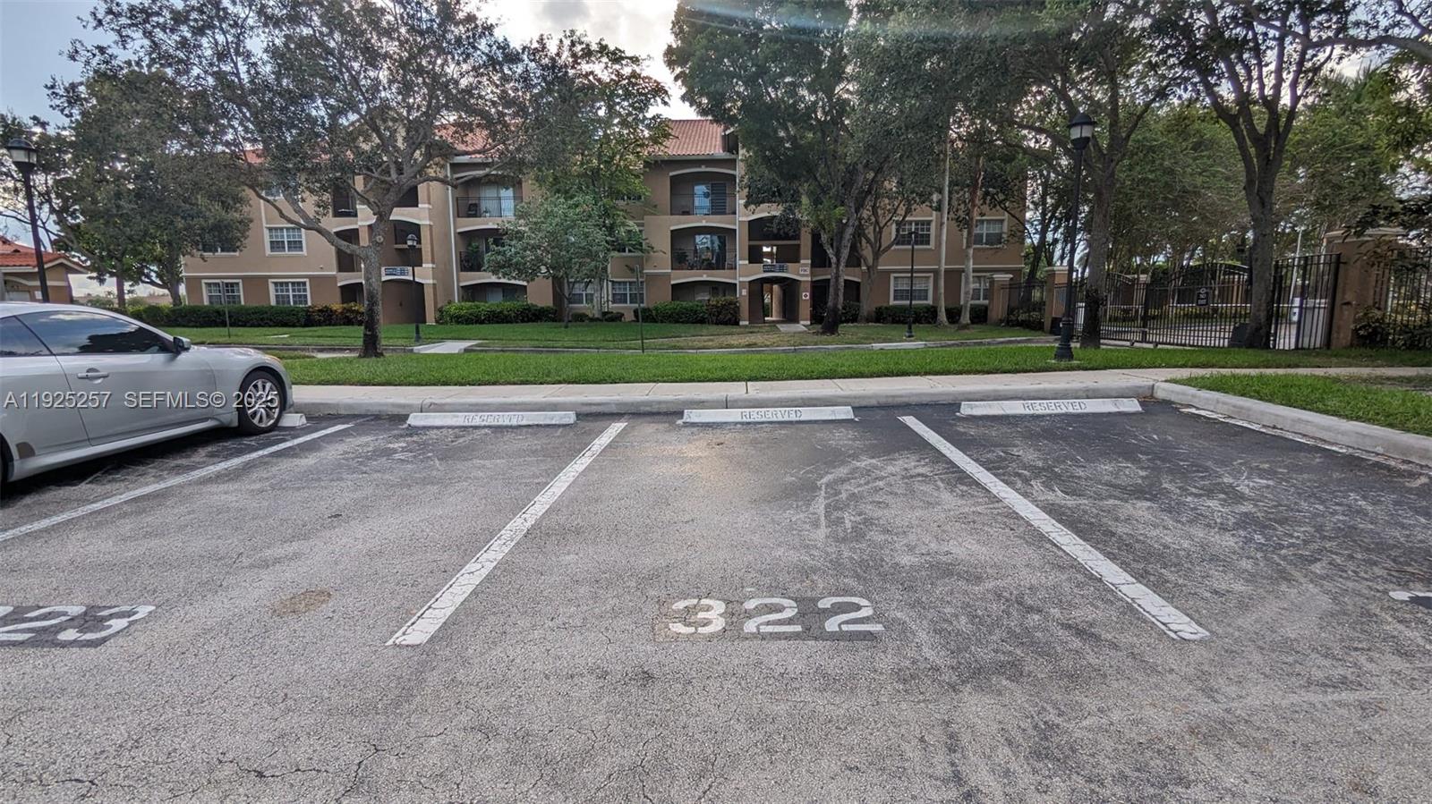 160 Southwest 117th Terrace, Unit 6106 Pembroke Pines, FL 33025 - Photo 20 of 28 a view of a street with a building and a street sign