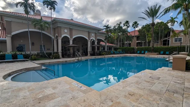 a swimming pool with outdoor seating and yard