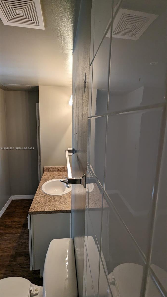 160 Southwest 117th Terrace, Unit 6106 Pembroke Pines, FL 33025 - Photo 4 of 28 a bathroom with a sink toilet and mirror