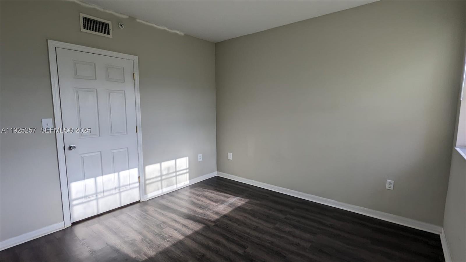 160 Southwest 117th Terrace, Unit 6106 Pembroke Pines, FL 33025 - Photo 6 of 28 an empty room with wooden floor and windows