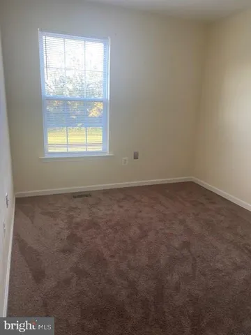 a white toilet sitting next to a bath tub