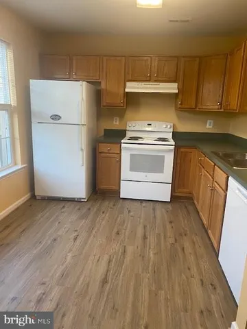 a kitchen with a stove a refrigerator and a sink