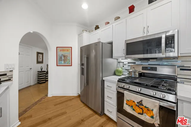 a kitchen with stainless steel appliances a stove a microwave and a refrigerator
