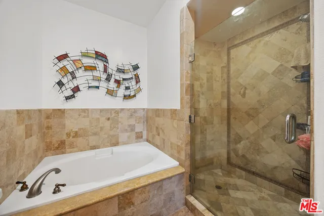 a bathroom with a tub and a shower