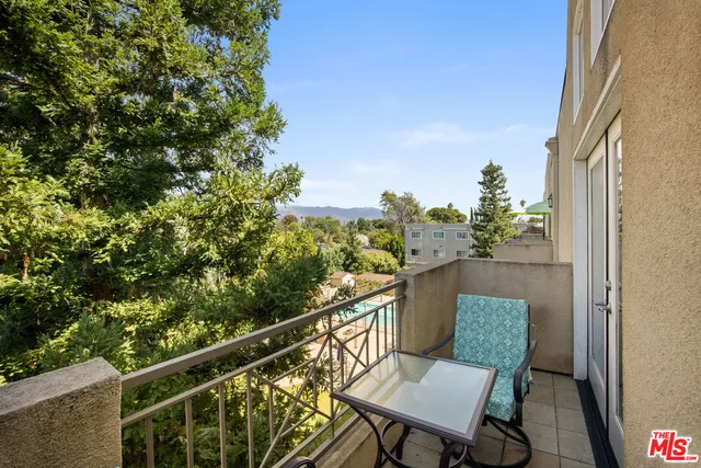 a balcony with table and chairs