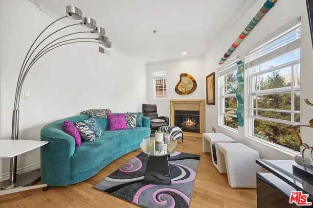 a living room with fireplace furniture and a wooden floor
