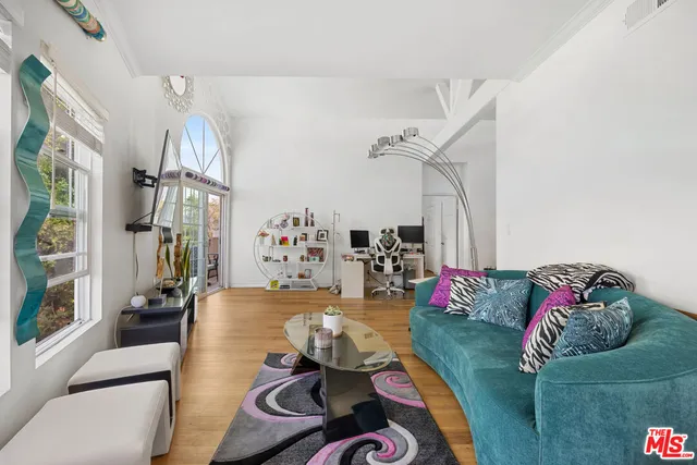 a living room with furniture chess board and a couch