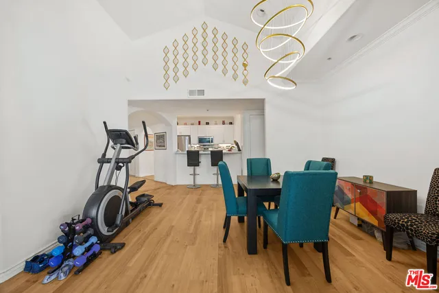 a view of a room that has a table and a chair in it