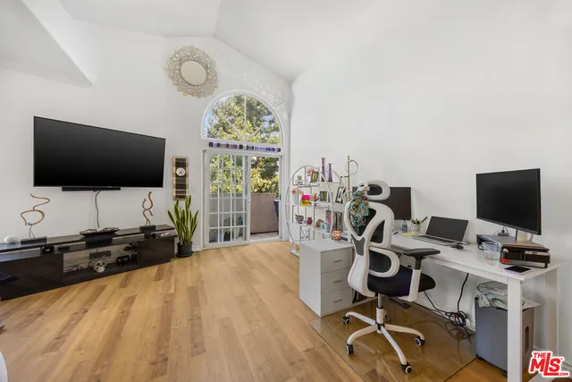 a view of a workspace with furniture and a flat screen tv