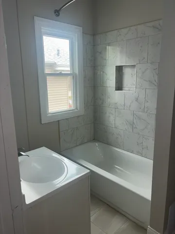 a white bath tub sitting next to a white sink