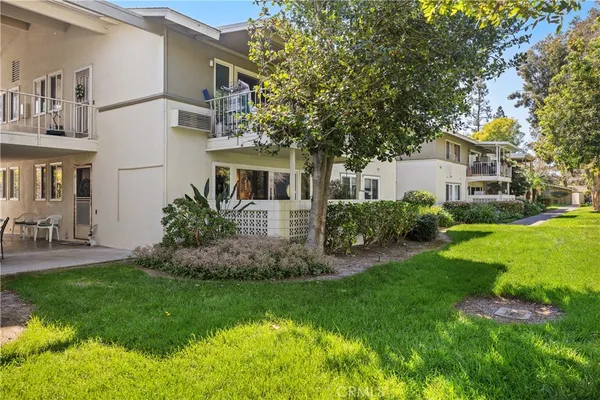 a view of a house with a yard and sitting area