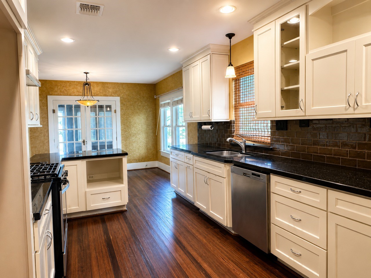 1726 7th Street Rosenberg, TX 77471 - Photo 5 of 17 Bright, spacious kitchen with modern appliances, cream cabinetry, and dark countertops.