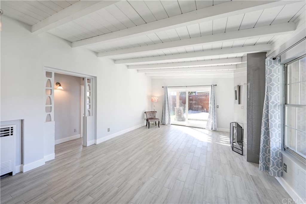 145 Avenida Mateo San Clemente, CA 92672 - Photo 4 of 10 a big room with wooden floor and a fireplace
