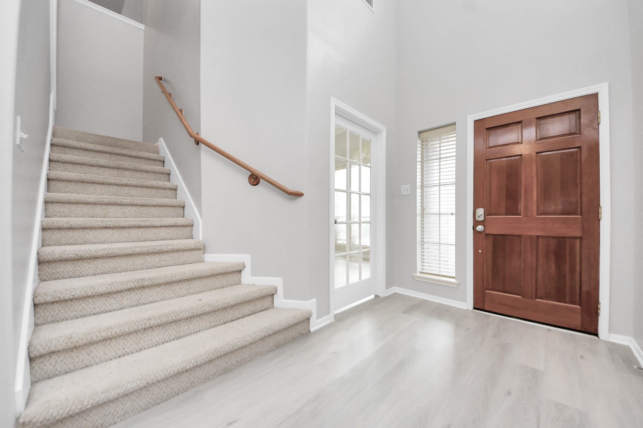 6803 Chapelfield Lane Houston, TX 77049 - Photo 12 of 50 a view of entryway with wooden floor and stairs
